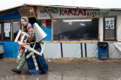 A man walks past a makeshift restaurant on Feb. 23, 2016 in the refugee camp in Calais.