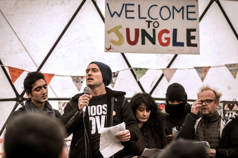 British actor Jude Law (center) speaks during a visit to the Jungle migrant camp in Calais on Feb. 21, 2016. 