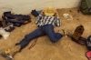 A bull rider stretches his legs in the preparation area. 