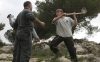 A Palestinian man confronts an Israeli settler, part of a group trying to prevent Palestinians from planting olive trees, near the southern West Bank city of Hebron on Jan. 1, 2010.