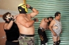 Luchadores help each other put on their outfits in the dressing room before their match. Gender-bending characters have become more common in Mexican wrestling. 