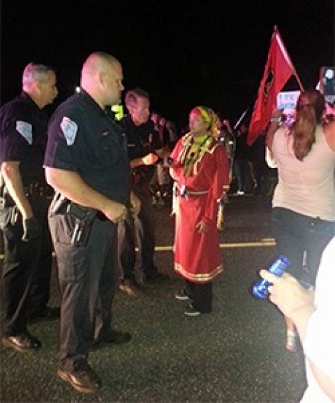Angela Picard, center, in her red wing dress the night she was arrested for disorderly conduct.