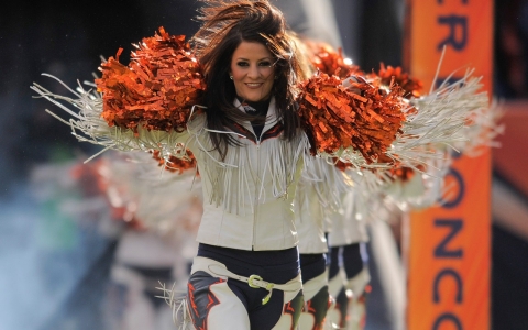 Denver Broncos cheerleader Tara Battiato leads the squad onto the field.