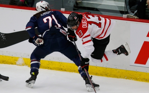 U.S. women's hockey player Hilary Knight sends Canada's Caroline Oulette flying with a check during a recent exhibition game.