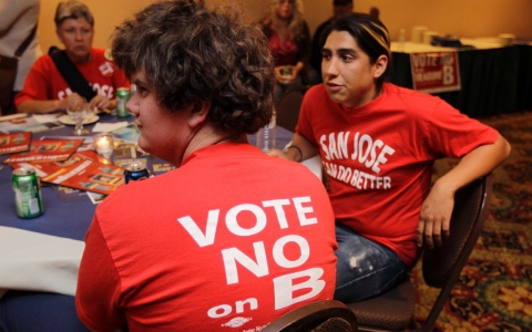 Campaign worker Nate Neuenschwander, left, watches election returns at a campaign party for people voting "No" on Measure B, which supported the state in attempting to cut pensions of public workers, in San Jose, Calif., on June 5, 2012.