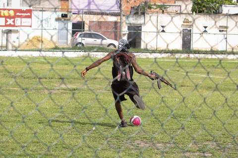 A Third Pure Command drug trafficker kicks the ball in Vila Alianca field
