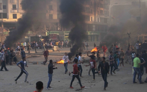 Protesters run during clashes with police in Ain Shams area