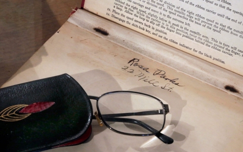 A pair of eyeglasses and and a typing textbook that belonged to Rosa Parks are displayed at Guernsey's auction house in New York.