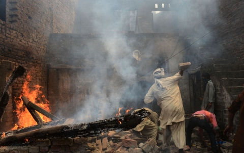 Demonstrators burn homes belonging to Christians accused of blasphemy in Lahore, Pakistan in March 2013.
