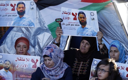 Palestinian hunger striker wakes from coma, vows to continue protest