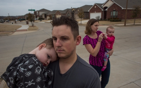 Alyse and Lance Ogletree and their children, Kage and Kyle, in the Meadows neighborhood in Denton. Their living room is 100 feet from a fracked well.