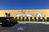 A mural of a bare-armed man and woman adorns the exterior of the school.