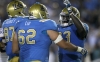 UCLA guard Alberto Cid (62) celebrates with his teammates after a touchdown during a game on Sept. 10, 2011. Cid was forced to retire in April.