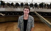 Kyle standing in the milking parlor.