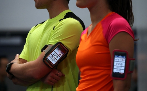 Models wear smartphones that collect fitness data from the Casio STB-1000 bluetooth enabled watch at the 2014 International CES in 2014.